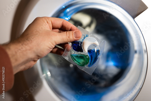 Close-up of a laundry pod with blue and green liquid detergent