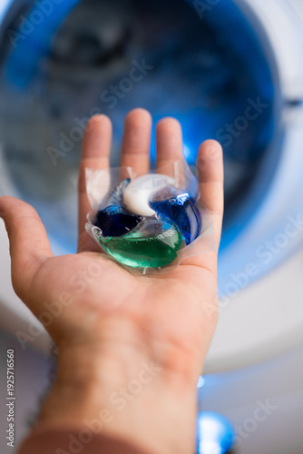 Close-up of a laundry pod with blue and green liquid detergent