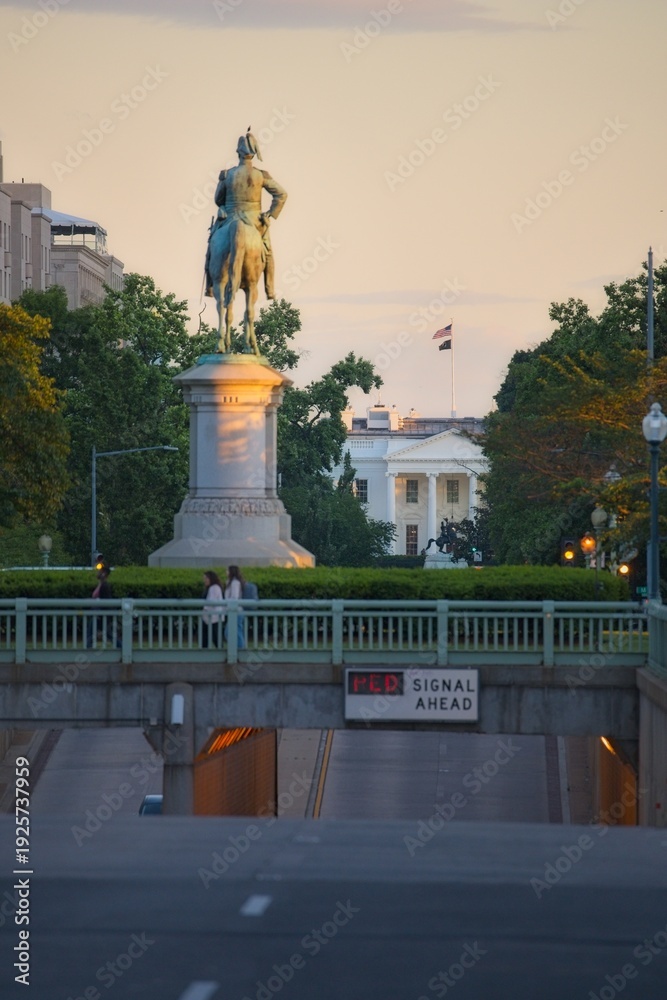 Fototapeta premium Person crossing the street at sunset in washington dc