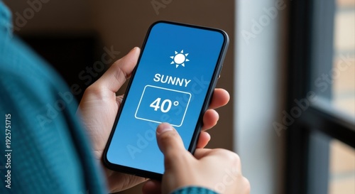 Wallpaper Mural Person Checking Sunny Weather Forecast on Mobile Phone, Displaying a Temperature of 40 Degrees Torontodigital.ca