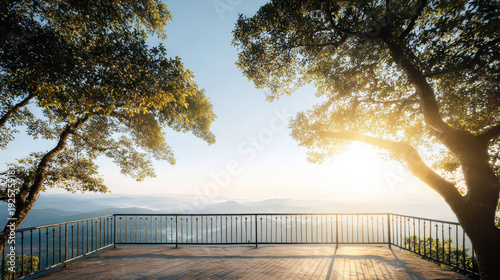 Outdoor wooden deck with metal railing offering a tranquil vista of distant mountains and valleys, illuminated by golden dawn sun