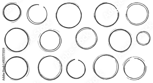 Collection of various sized silver rings on white background.