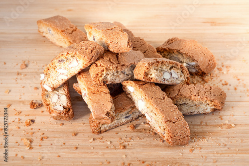 cookies with nuts lie in a heap on a wooden table