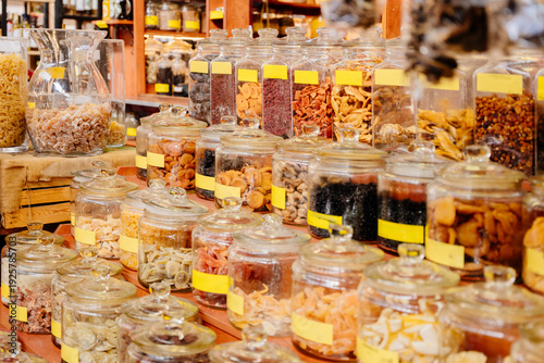 Fotografija Bulk food store shelves with glass jars of dried fruits spices nuts, zero waste