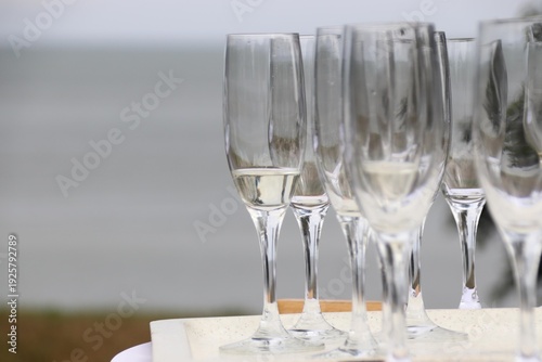 Glasses and sparkling wine on a white standing table on the beach create a festive atmosphere, Sylt, Keitum