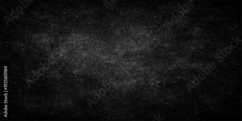 A dark grunge backdrop featuring an old textured stone wall with a vintage black and white paper pattern on a blank dirty concrete surface