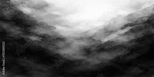 Dramatic dark storm clouds fill the moody blue sky during a summer weather transition creating an abstract nature background of light and shadow in the cloudy heaven