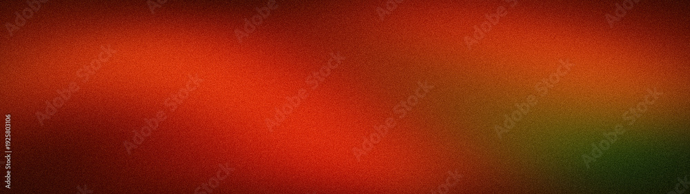 Fototapeta premium A wide, abstract grainy background featuring a dramatic blur of deep red, fiery orange, and dark forest green tones, creating a moody and atmospheric texture