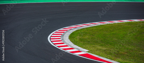 Bild auf Leinwand Empty racetrack curve with red and white curb.