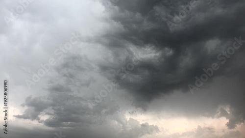 Time lapse video of mixed variable weather as storm clouds dissipate in the sky after rain. Soft sunlight breaks through misty air, revealing calm atmosphere. Hatay Dortyol Turkey.
