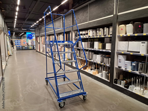 Metal mobile ladder for employees in a household goods supermarket