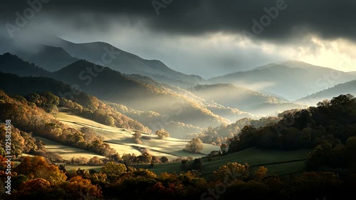 A landscape featuring layered, forested hillsides under a dark, cloud-filled sky, with sunlit fields