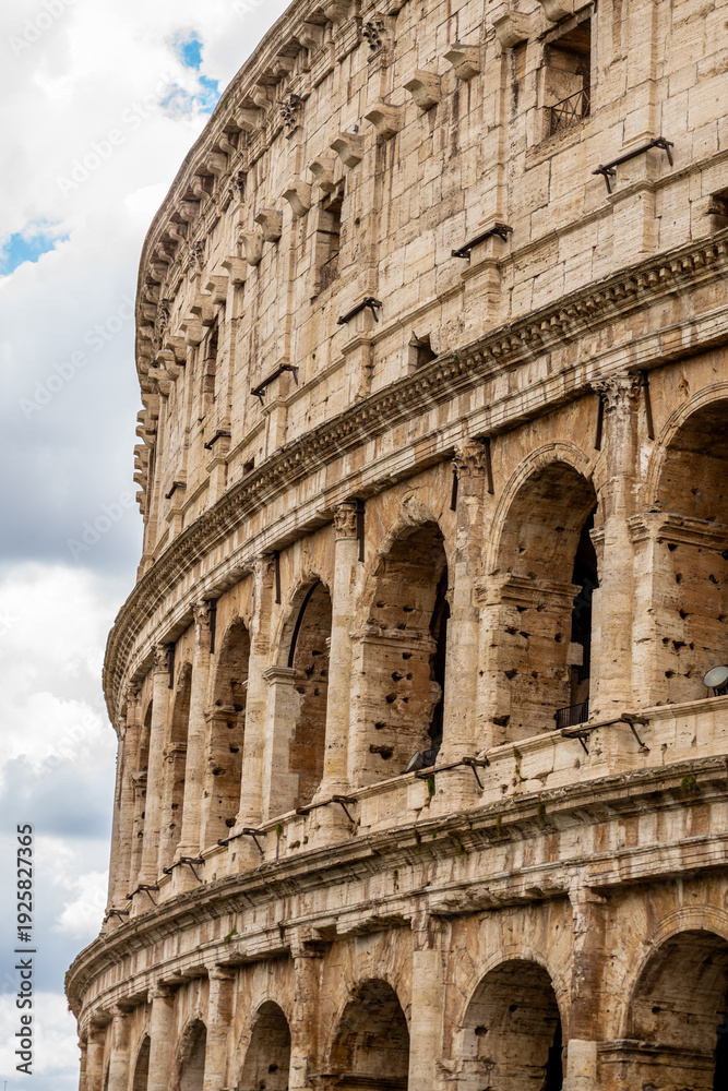 Fototapeta premium Famous tourist attraction of historic Colosseum amphitheatre with ancient stone arches in Rome Italy