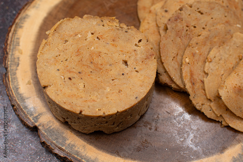 Plant based vital wheat gluten seitan as meat alternative. Sliced, on wooden board