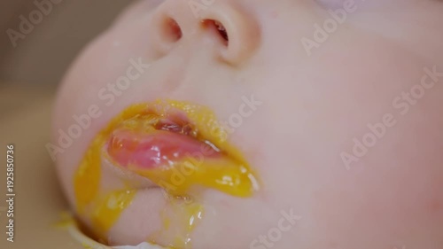 Wallpaper Mural Close up of a baby being fed with a spoon, showing facial details and soft expressions Torontodigital.ca