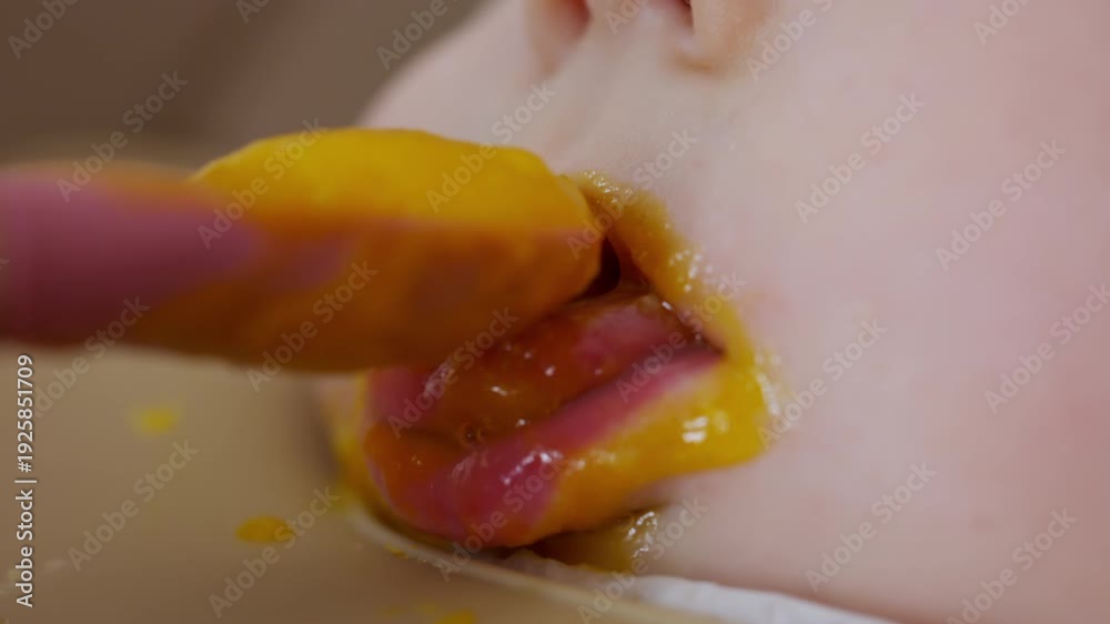 custom made wallpaper toronto digitalClose up of a baby being fed with a spoon, showing facial details and soft expressions