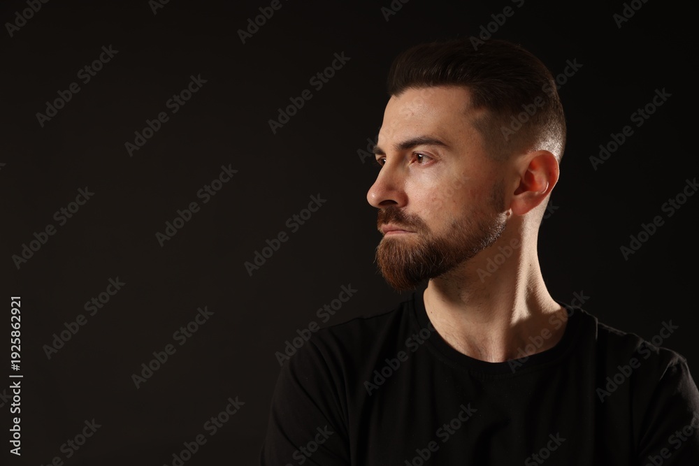 Fototapeta premium Bearded man on black background. Space for text