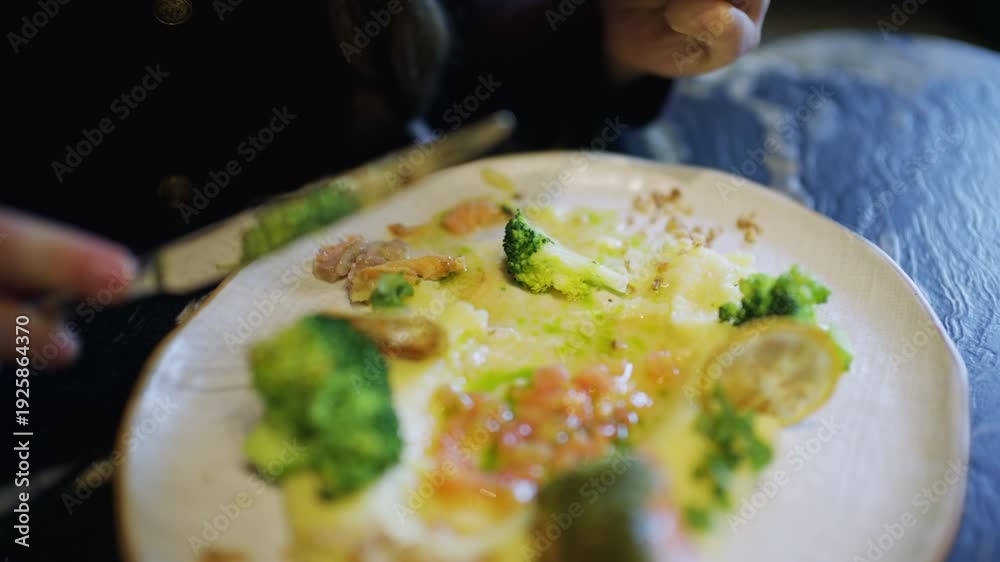 custom made wallpaper toronto digitalClose up of hands using knife and fork to cut a salmon fillet served with broccoli and sauce