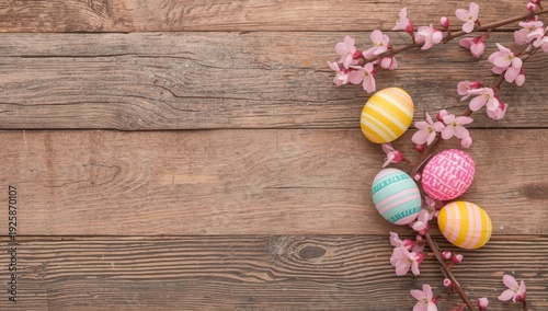 Colorful Easter eggs and pink cherry blossoms on rustic wooden background colorful eggs striped eggs