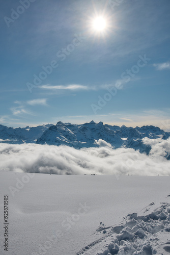 Sun above snowy alpine landscape, Stoos Switzerland