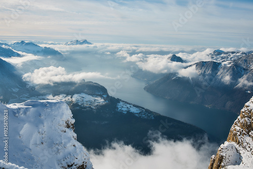 Snow covered alpine lake above sea of clouds, Stoos Switzerland