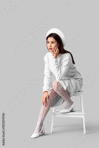 Stylish young woman in whit...