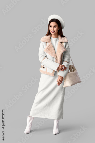 Stylish young woman in whit...
