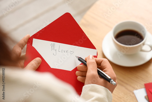 Young woman writing love le...