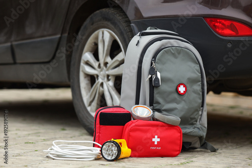 Bild auf Leinwand Emergency backpack, first aid kit and necessities near car outdoors