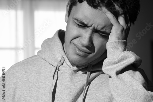 Upset young man at home, cl...