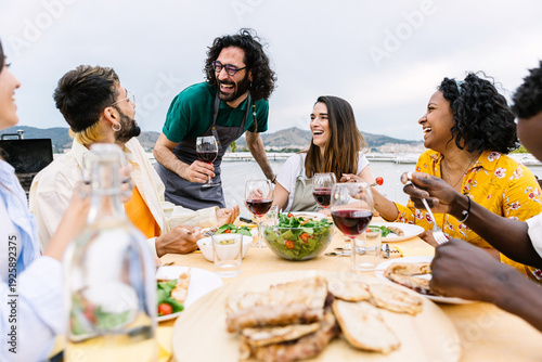 Принти на полотні Group of young friends having dinner at home terrace