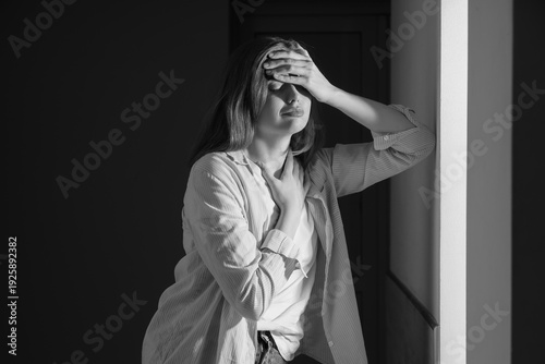 Depressed young woman in da...