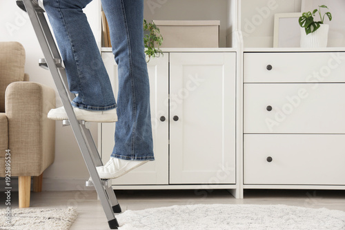 Legs of woman climbing step...
