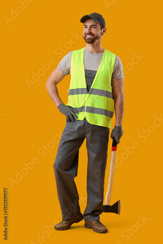 Male worker with ax on yell...