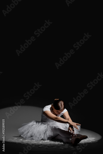 Young ballerina sitting on ...