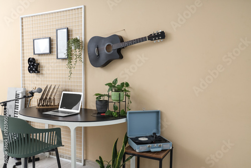 Workplace with guitar on be...