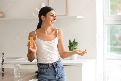 Young woman with vitamin E ...