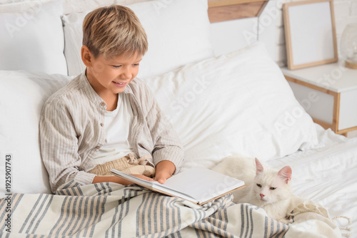 Little boy with cat reading...
