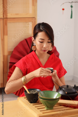 Young Asian woman with cup ...
