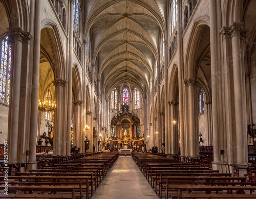 A long shot of a cathedral's interior with rows of benches and high ceilings