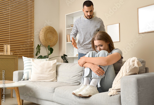 Crying young woman sitting ...