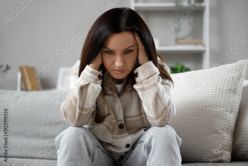 Worried woman sitting on so...