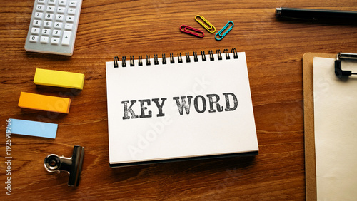 Business concept of Key Word represented on notebook with calculator, sticky note, clipboard. Ideal for marketing and promotional content.