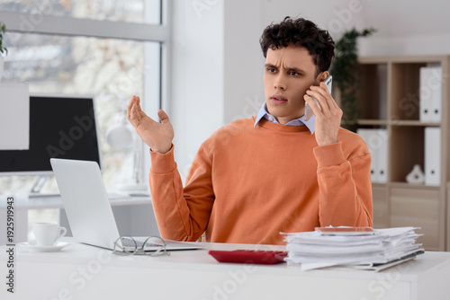 Stressed young man talking ...