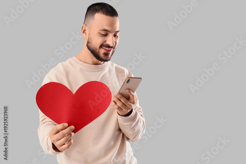 Smiling young man holding r...