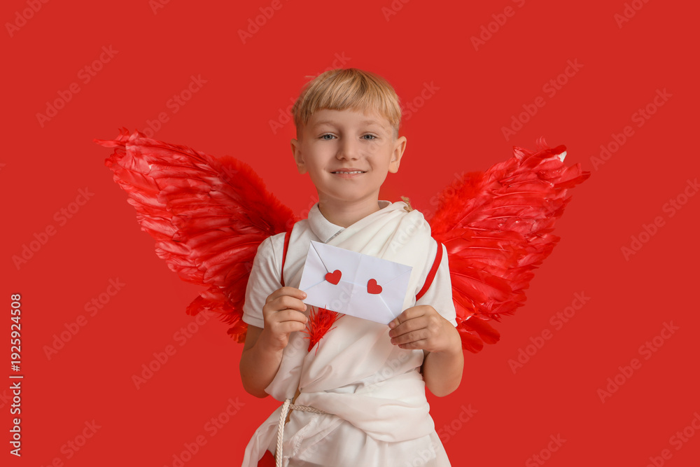 Naklejka premium Cute little happy boy dressed as cupid with arrow and love letter on red background. Valentine's Day celebration