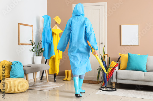 Woman with raincoat and umb...