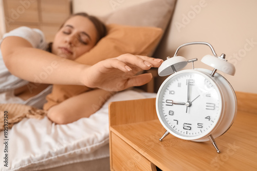 Young woman in pajamas turn...
