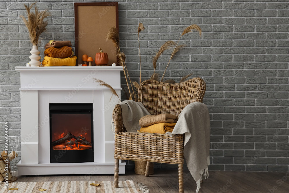 Naklejka premium Stylish interior of modern room with fireplace and clean warm clothes