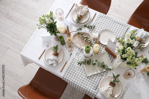 Beautiful table setting with eustoma flowers and eucalyptus for wedding celebration in room, top view